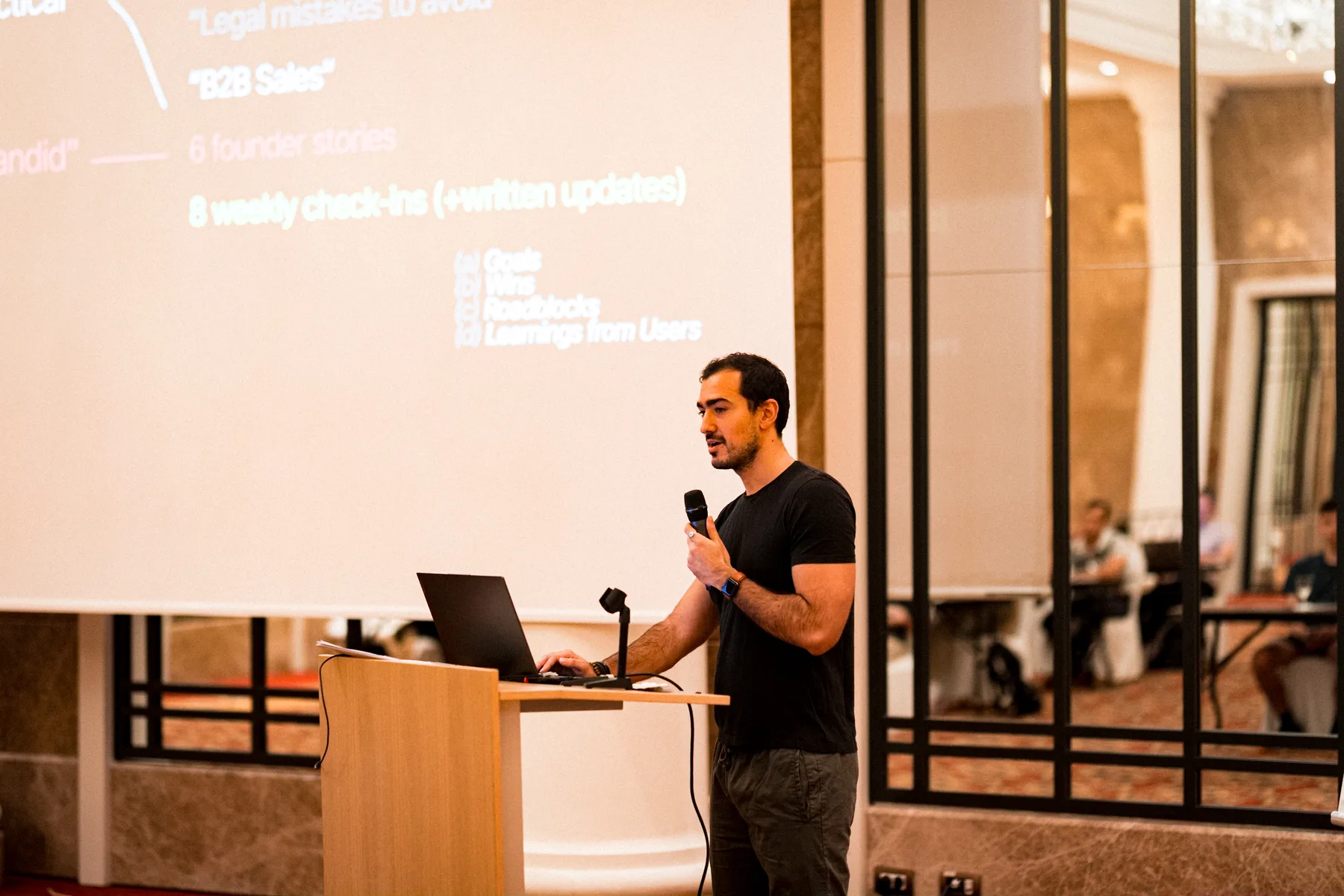 Speaker presenting on stage at a Barcelona business event