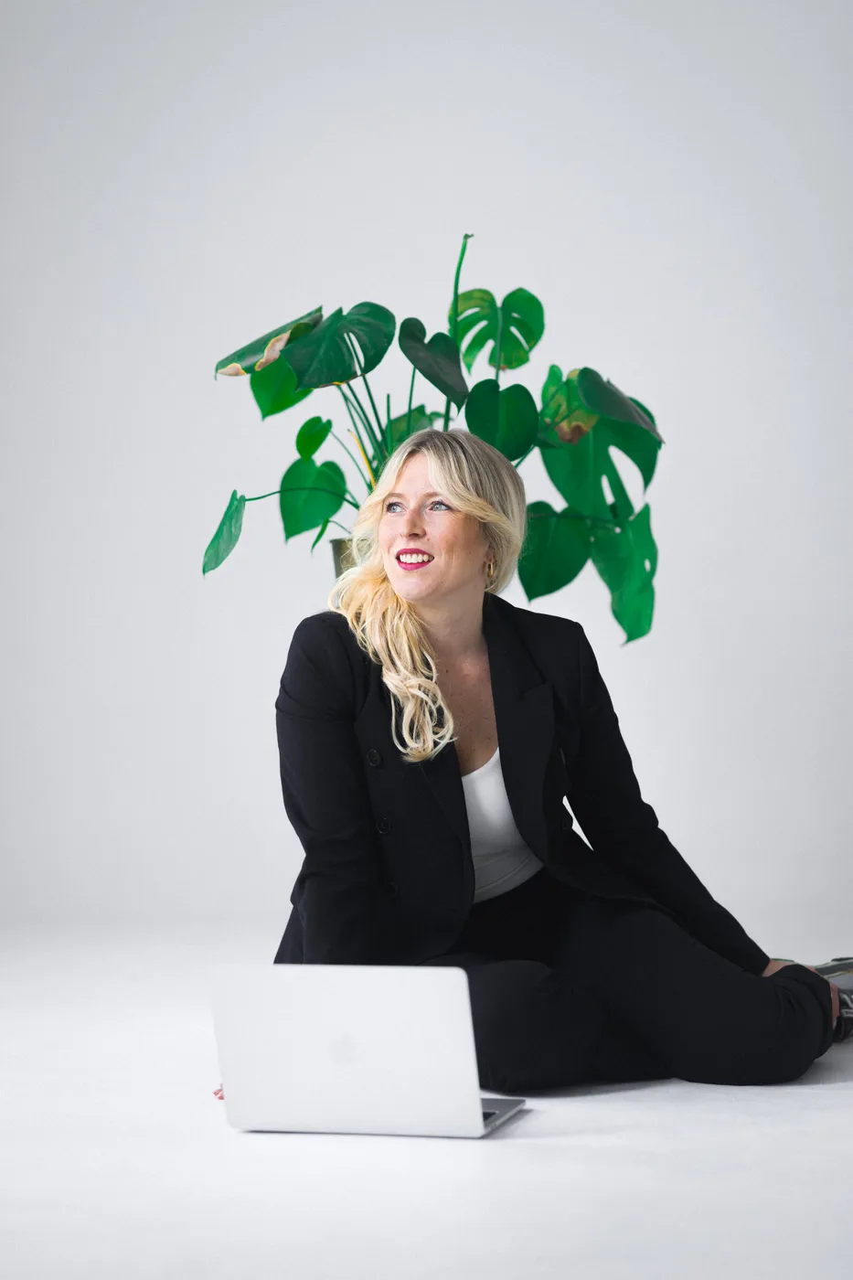 Business portrait of a woman with a laptop in a studio