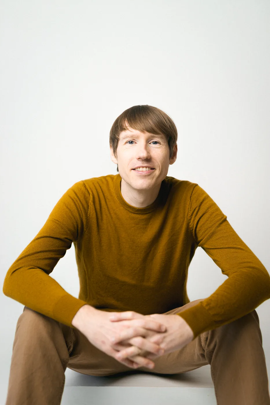 Relaxed corporate headshot of a young professional
