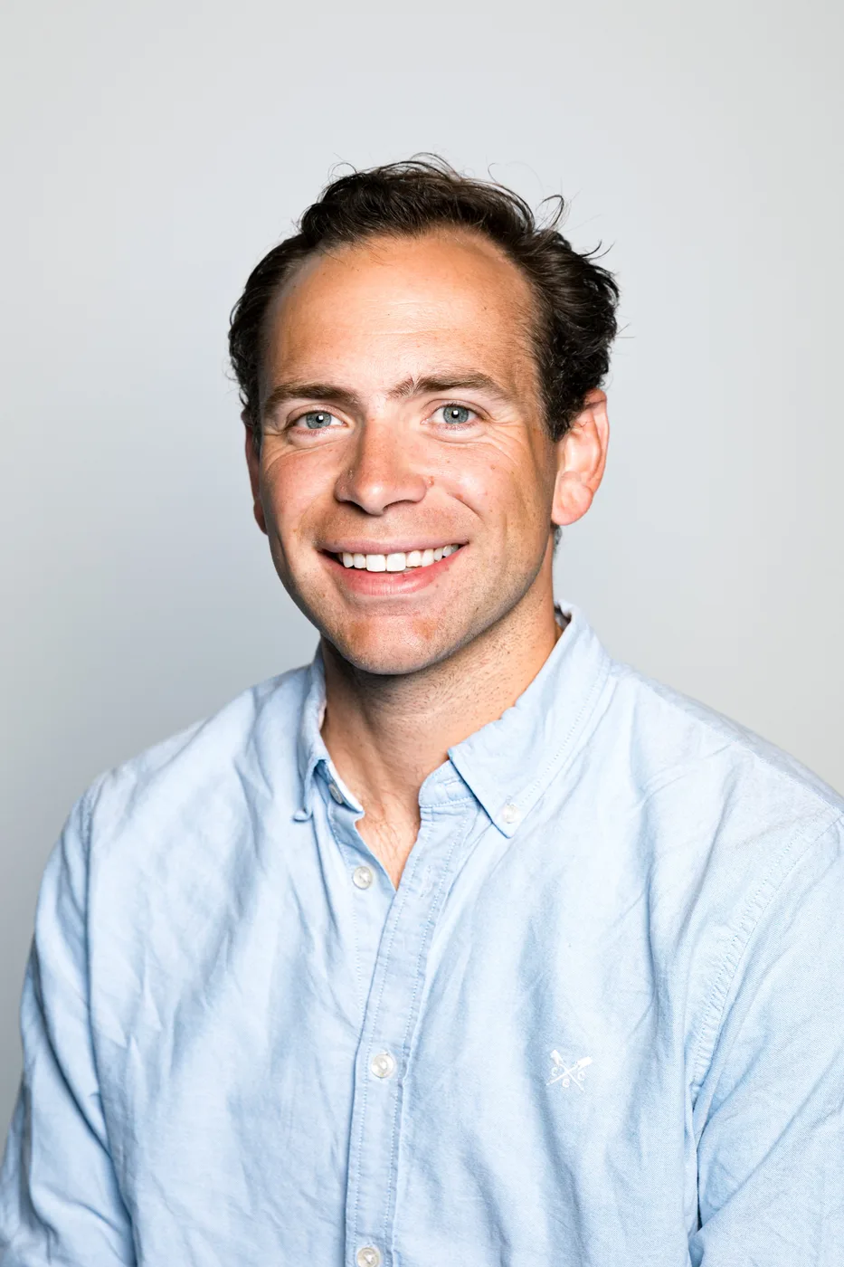 Classic corporate headshot on a neutral background