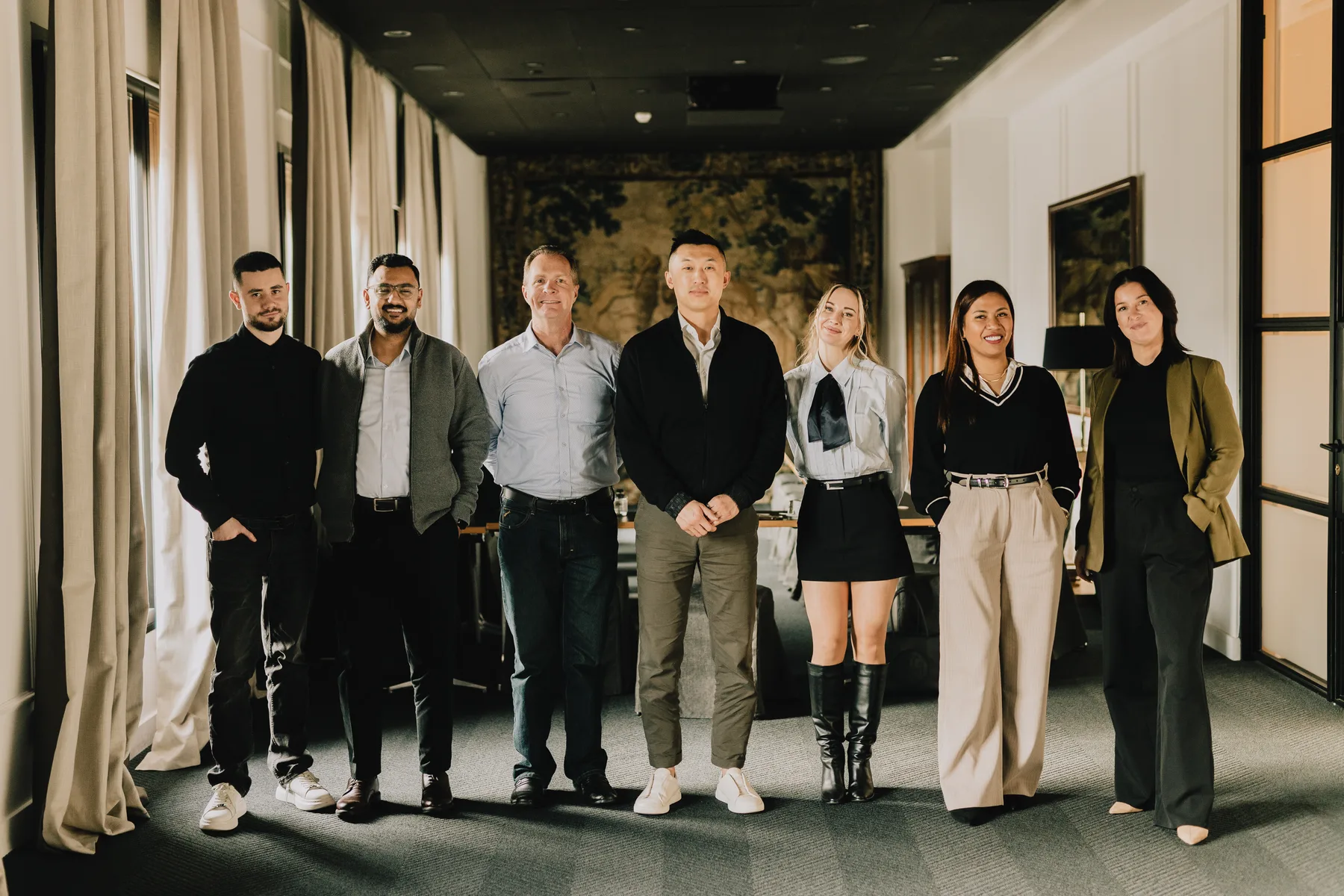 Company team group portrait in a Barcelona office corridor